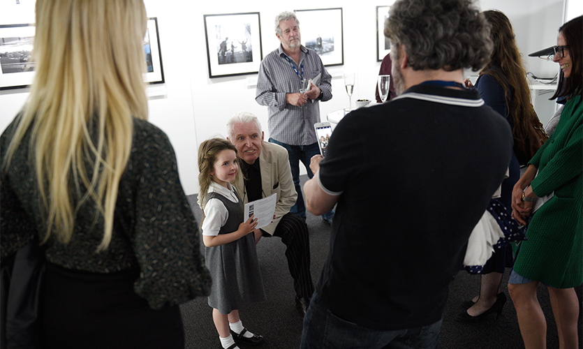 Mike McCartney posing for a picture with a young fan