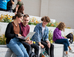 Students studying outside LJMU with plants in background