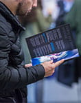 Image of a man reading a postgraduate brochure